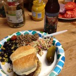 A plate of cookout food and craft beer
