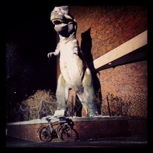 Seven at night in front of the T-Rex sculpture at Boston's Museum of Science