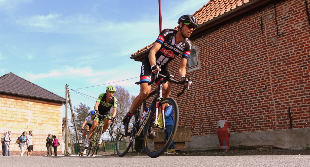 Three cyclists in a racing around a corner
