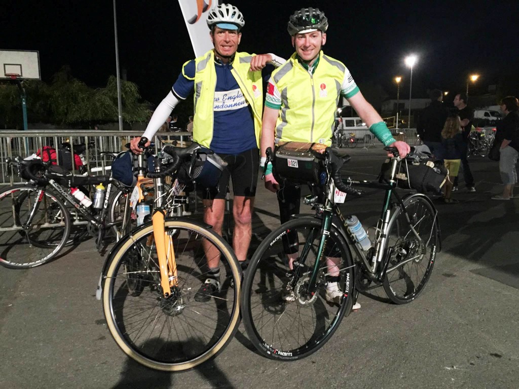 Two smiling night cyclists posing with their Sevens