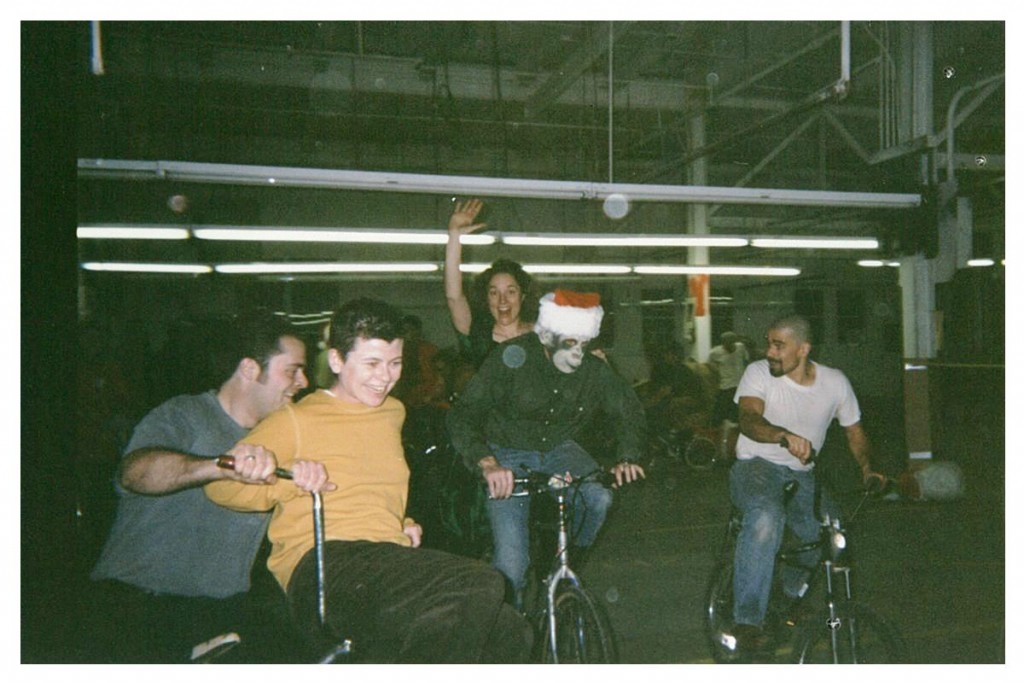 Folks riding doubles and laughing in an otherwise empty factory building