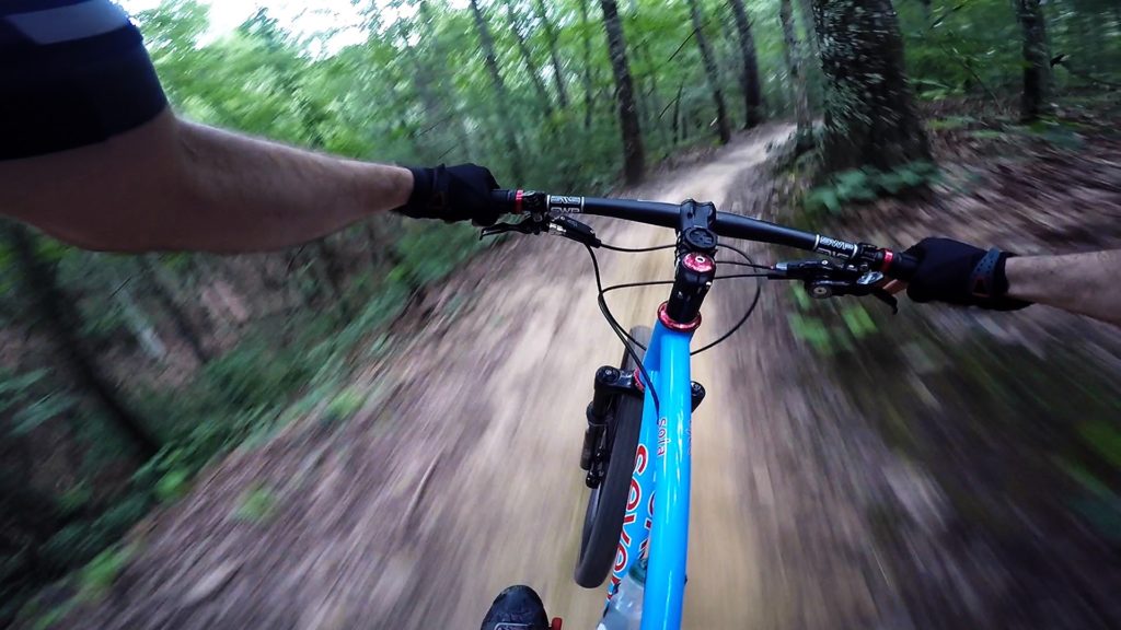 Seven Sola flying down a fast singletrack