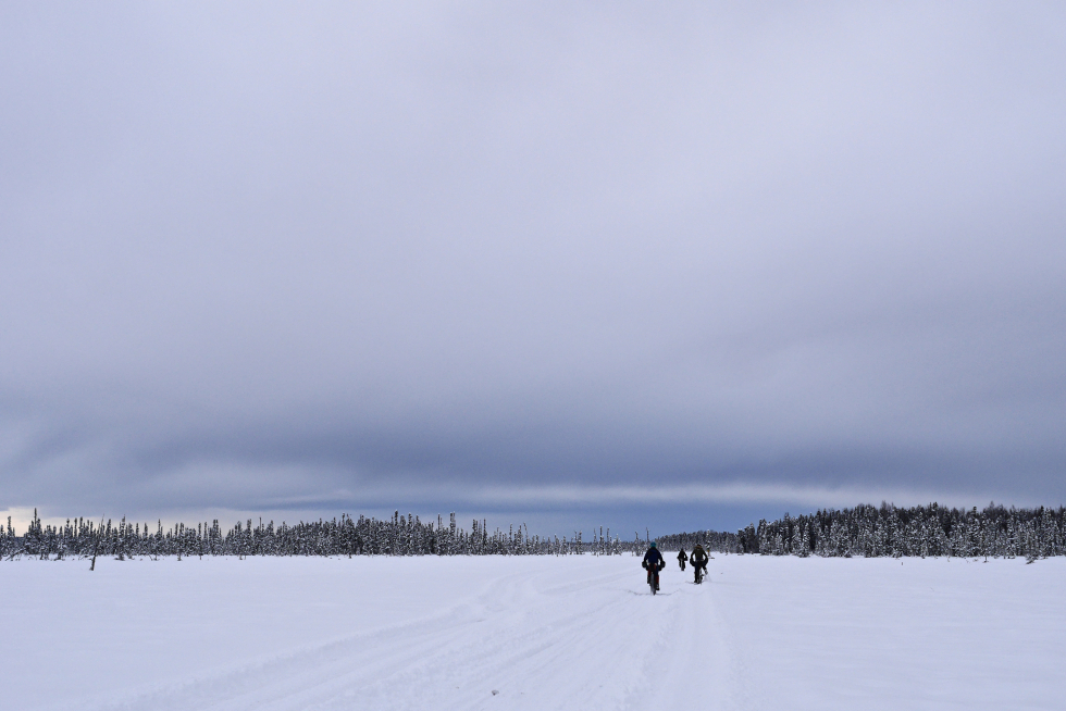 distant riders on the snow covered tundra