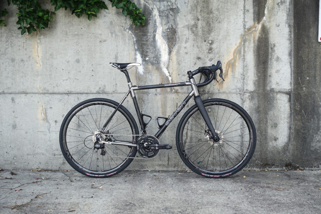 A pristine Mudhoney PRO strikingly poses against a weathered concrete wall