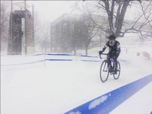 A snow covered and bearded Bradford Smith plows up a snowy track at CX Nationals
