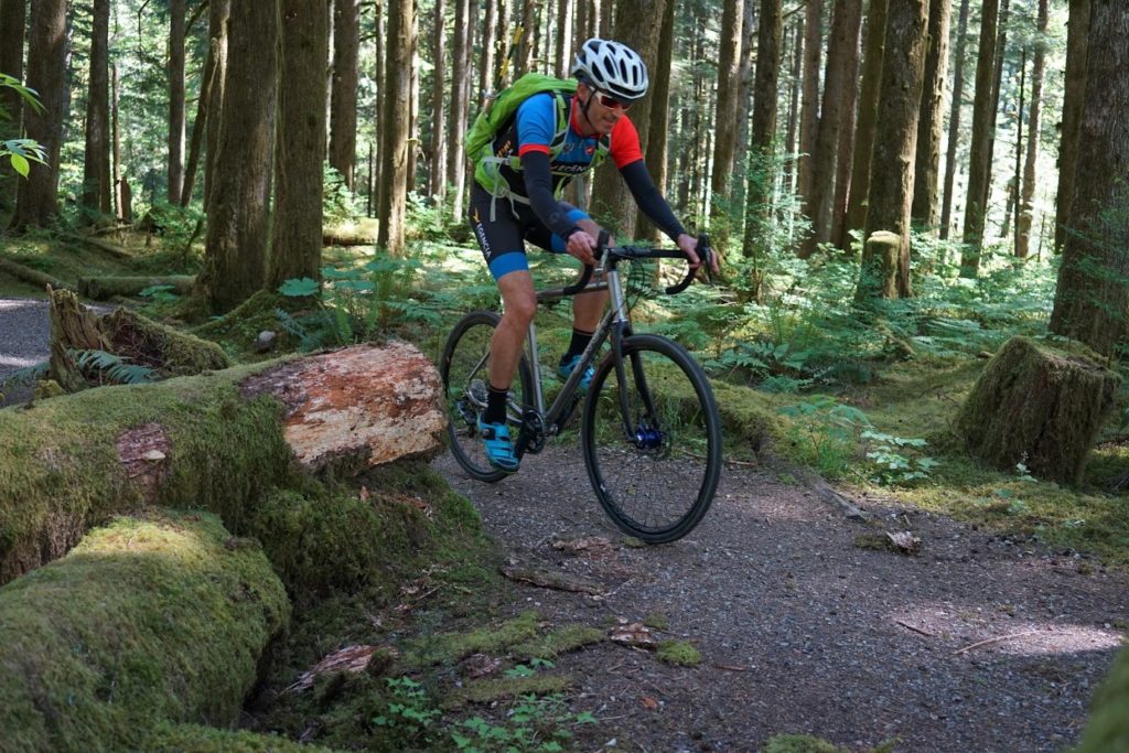 Jeremy smiles as he rides his Seven in the woods