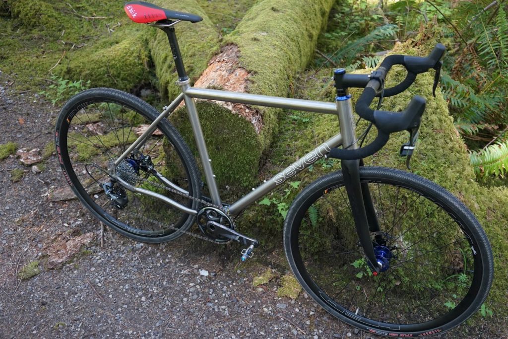 Jeremy's sleek road bike leans against a mossy log