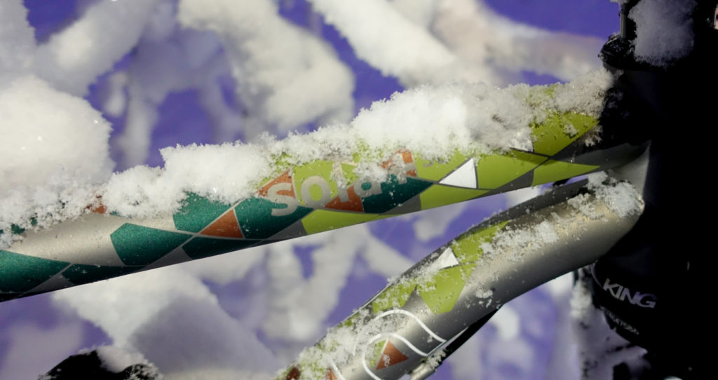A 'Four Seasons' painted Sola + SL top tube covered in snow