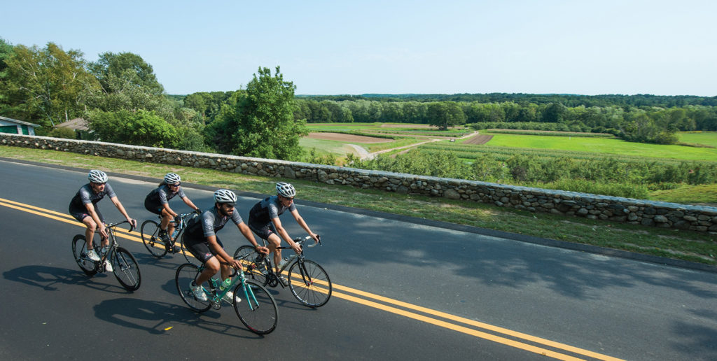 four riders on a flat stretch of road
