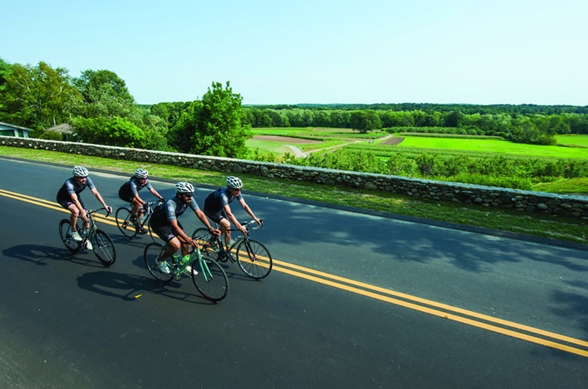 four riders on a flat stretch of road